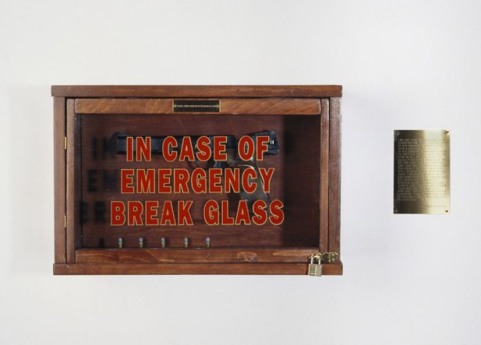 1990; wood, gun, bullets, text on signs; 12 x 24 x 8 inches